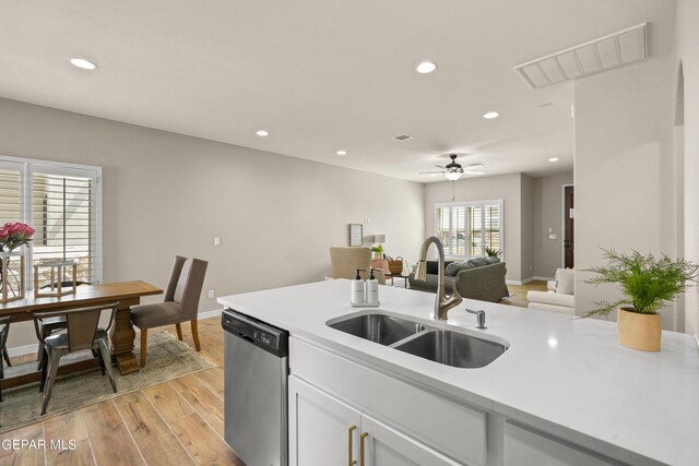 921 Raegil St, El Paso, TX 79928 - kitchen with a sink, stainless steel dishwasher, recessed lighting, light countertops, and light wood-type flooring
