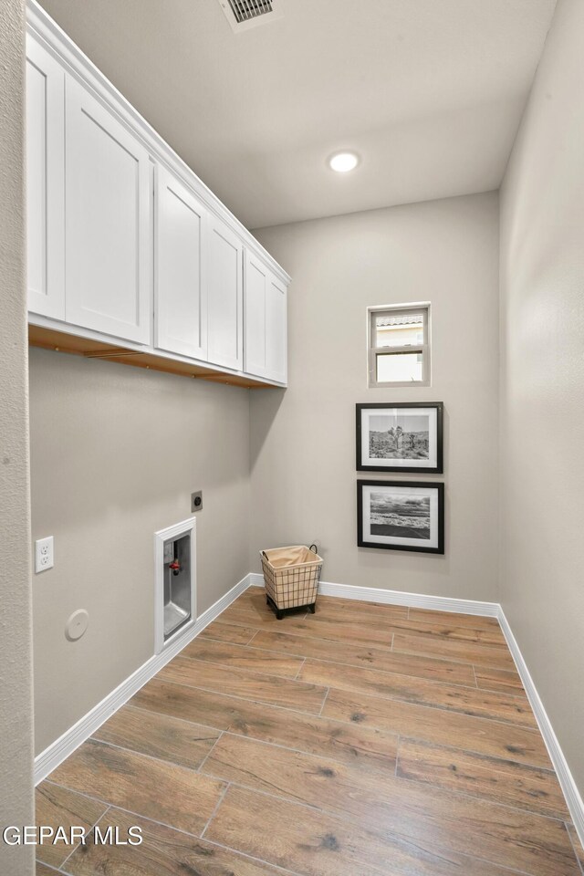 921 Raegil St, El Paso, TX 79928 - laundry area featuring hookup for an electric dryer, cabinet space, light wood-type flooring, recessed lighting, and baseboards