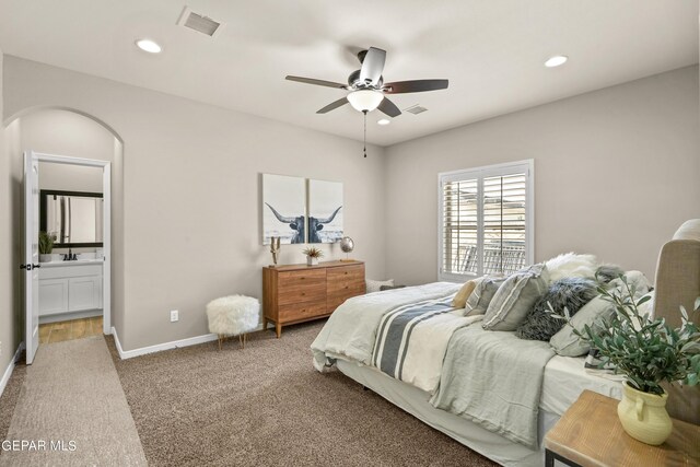 921 Raegil St, El Paso, TX 79928 - carpeted bedroom with arched walkways, recessed lighting, baseboards, ensuite bathroom, and ceiling fan