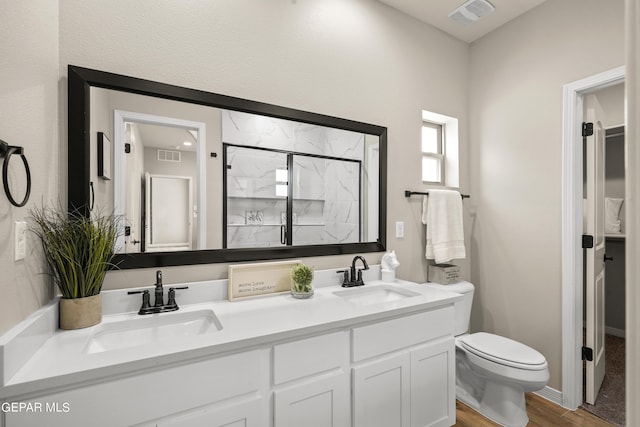 921 Raegil St, El Paso, TX 79928 - bathroom with wood finished floors, toilet, double vanity, and a shower stall