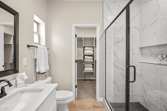 921 Raegil St, El Paso, TX 79928 - bathroom with a stall shower, wood finished floors, vanity, and toilet