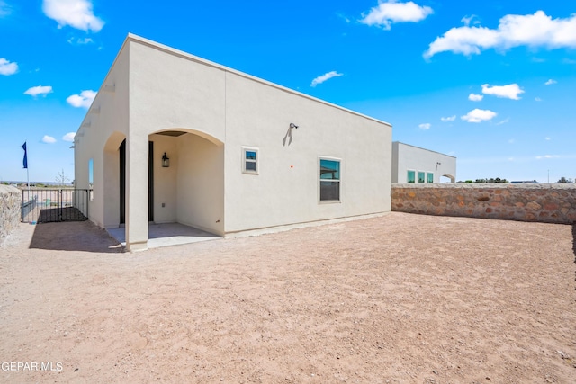 921 Raegil St, El Paso, TX 79928 - rear view of property featuring a patio, stucco siding, and a fenced backyard