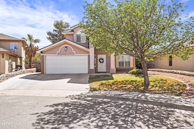 view of front of house featuring concrete driveway, stucco siding, and a garage
