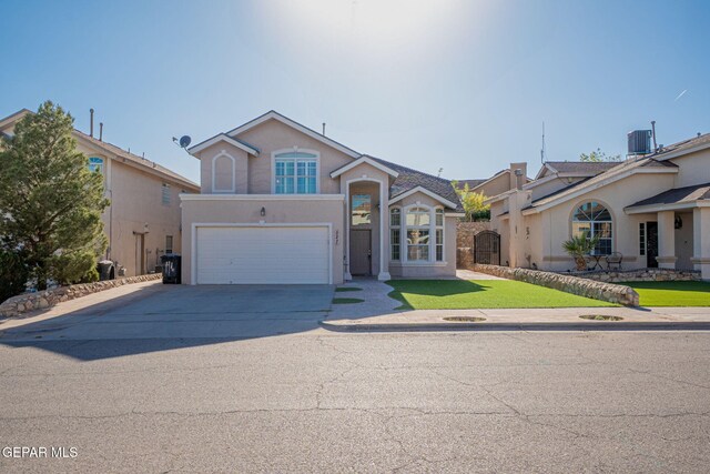 527 Longleaf Pl, El Paso, TX 79928 - traditional-style home with driveway, central AC, a front lawn, an attached garage, and stucco siding