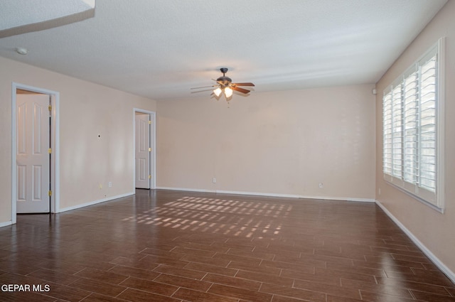 527 Longleaf Pl, El Paso, TX 79928 - unfurnished living room with baseboards, a ceiling fan, and dark wood finished floors