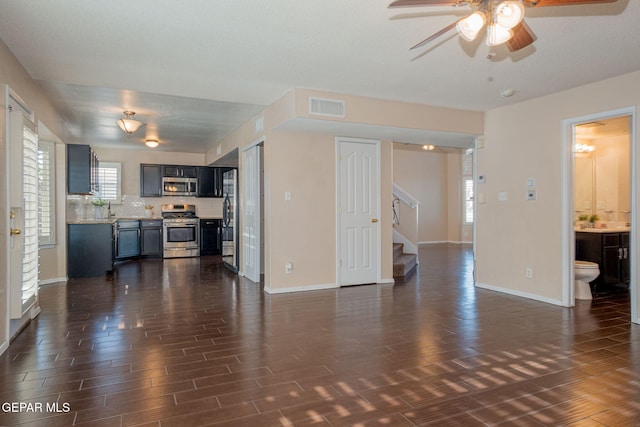 527 Longleaf Pl, El Paso, TX 79928 - unfurnished living room featuring a ceiling fan, visible vents, baseboards, dark wood-style floors, and stairs