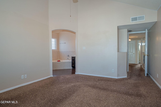 527 Longleaf Pl, El Paso, TX 79928 - spare room featuring visible vents, arched walkways, baseboards, high vaulted ceiling, and carpet flooring