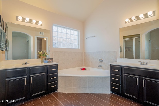 527 Longleaf Pl, El Paso, TX 79928 - bathroom with a garden tub, a sink, two vanities, and vaulted ceiling