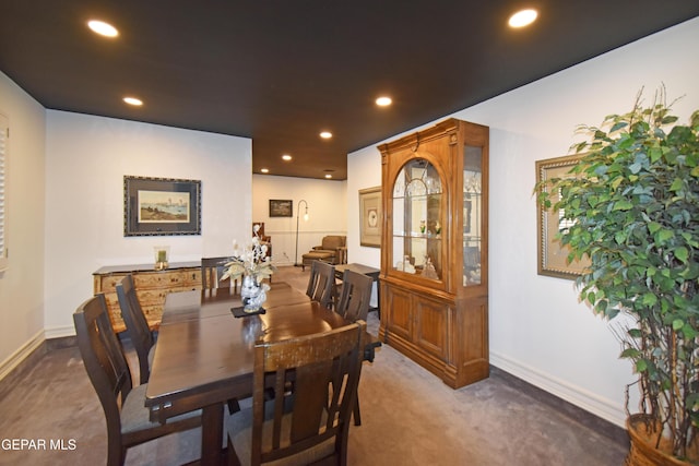 carpeted dining space featuring baseboards and recessed lighting