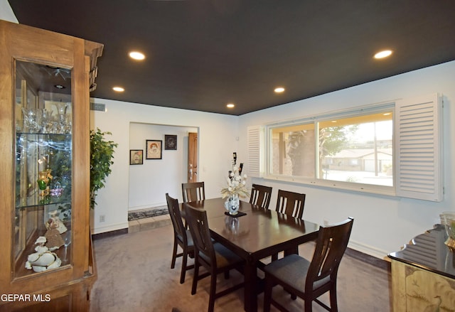 carpeted dining space with baseboards and recessed lighting