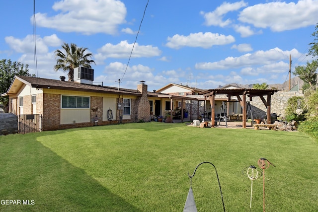 rear view of property featuring brick siding, a yard, a pergola, and a patio