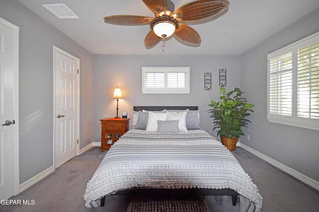 carpeted bedroom featuring baseboards, visible vents, and a ceiling fan