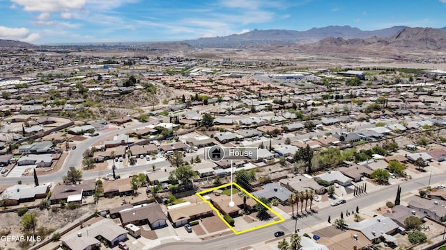 drone / aerial view featuring a residential view and a mountain view
