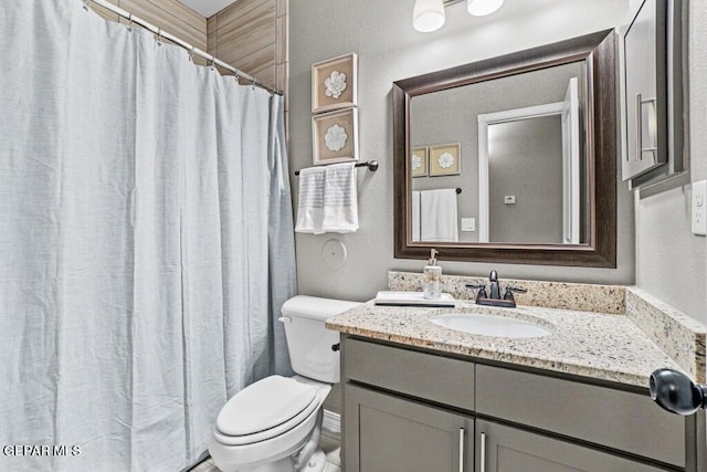 bathroom featuring toilet, a shower with curtain, and vanity
