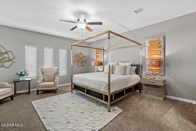 carpeted bedroom featuring baseboards, ceiling fan, and visible vents