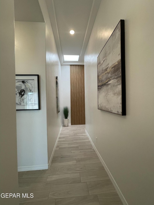 hallway with baseboards and recessed lighting