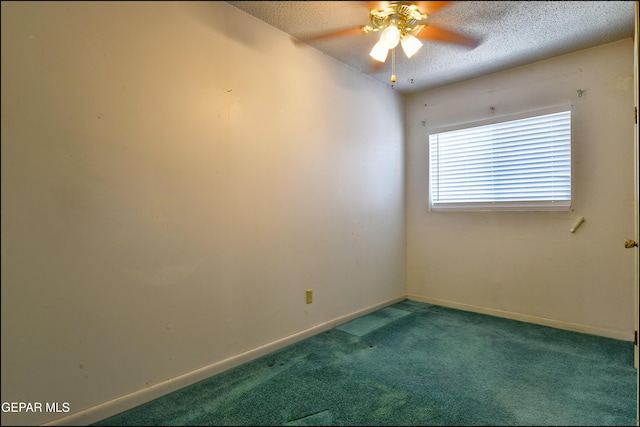 spare room with a textured ceiling, a ceiling fan, carpet, and baseboards