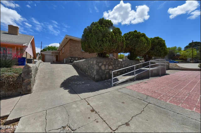 view of property exterior with fence and a detached garage