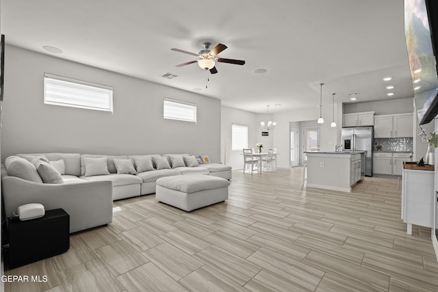 13740 Lago Vista Ave, El Paso, TX 79928 - living room featuring ceiling fan and a chandelier