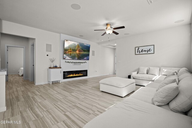 13740 Lago Vista Ave, El Paso, TX 79928 - living room featuring a ceiling fan, a glass covered fireplace, and baseboards