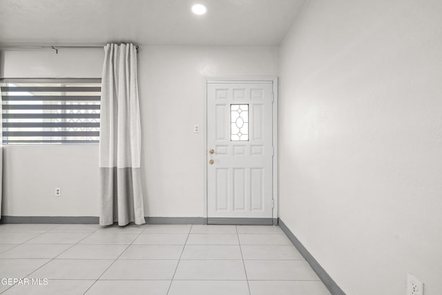 entryway with light tile patterned floors, baseboards, and recessed lighting