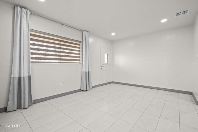 empty room with visible vents, baseboards, and recessed lighting