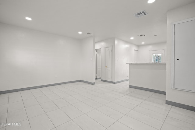 empty room with recessed lighting, visible vents, and light tile patterned flooring