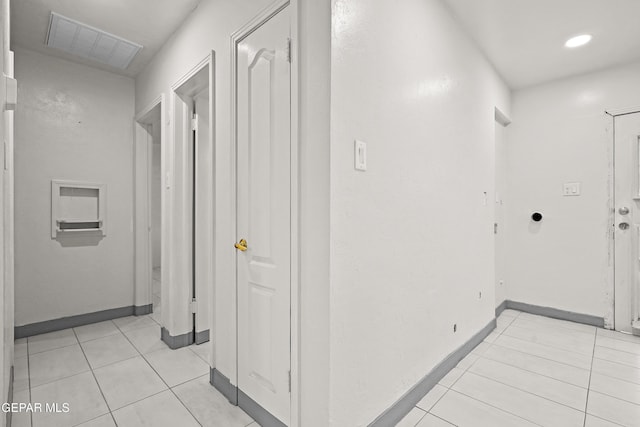 hallway featuring light tile patterned flooring, baseboards, visible vents, and recessed lighting