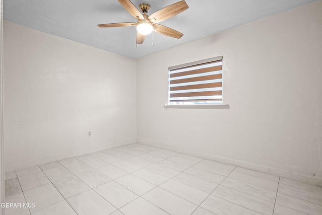 empty room featuring ceiling fan and light tile patterned floors