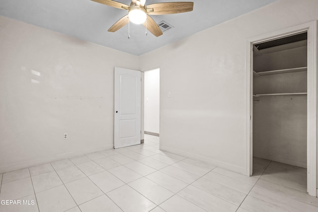 unfurnished bedroom featuring ceiling fan, light tile patterned flooring, a closet, and visible vents