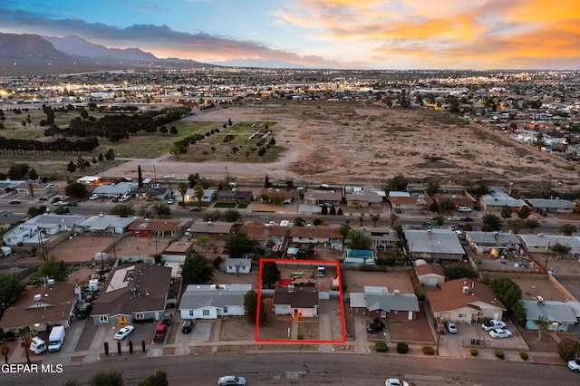 aerial view at dusk with a mountain view and a residential view