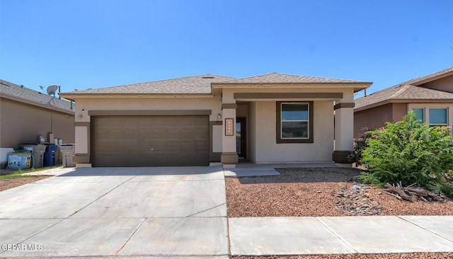 4929 Adrian Campos St, El Paso, TX 79938 - prairie-style house with a garage, stucco siding, driveway, and a shingled roof