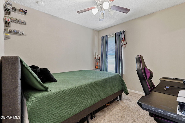 carpeted bedroom with a ceiling fan, a textured ceiling, and baseboards