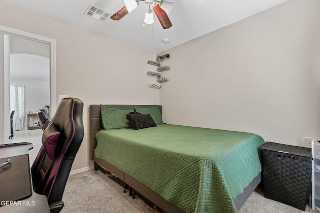 bedroom featuring light colored carpet, ceiling fan, and visible vents