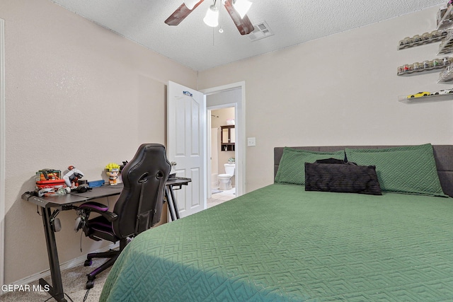 carpeted bedroom with visible vents, a textured ceiling, baseboards, and a ceiling fan