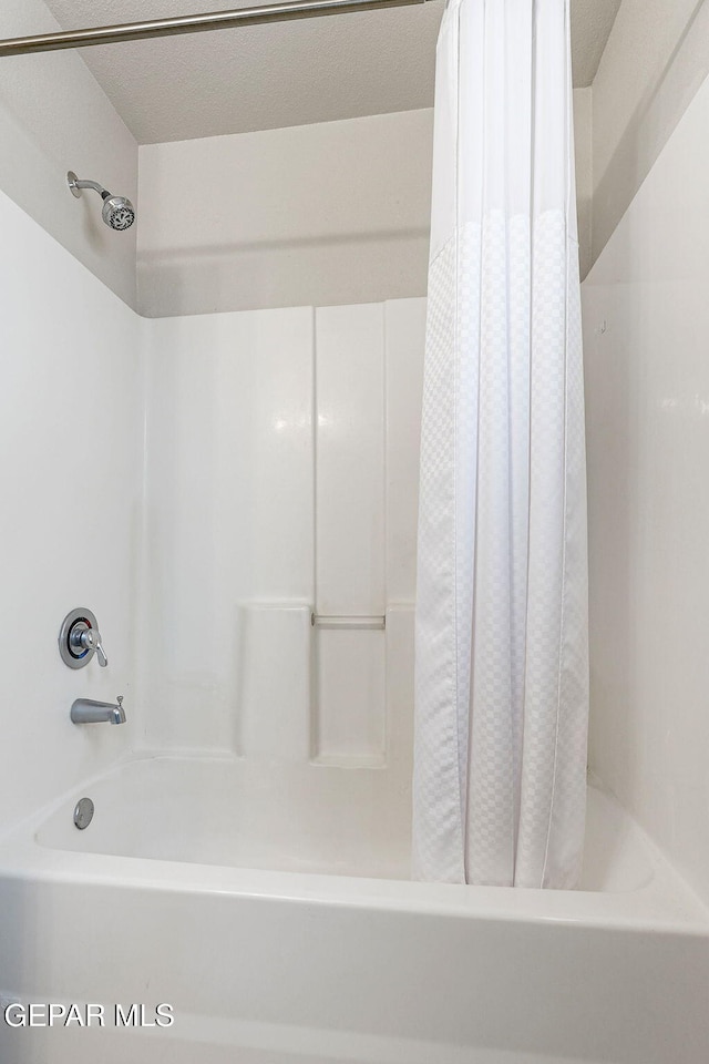 bathroom with shower / bathtub combination with curtain