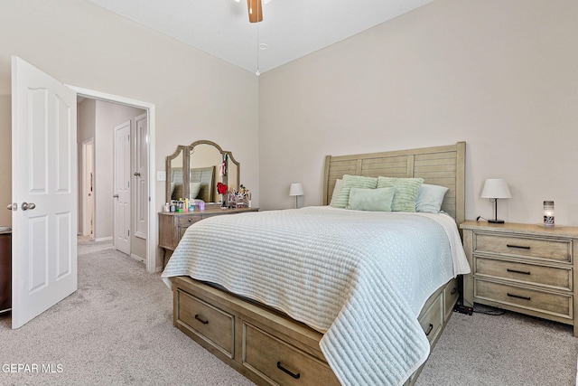 bedroom with a ceiling fan and light carpet