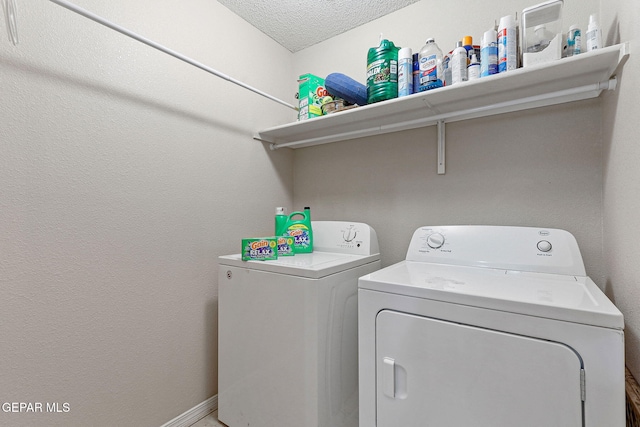 laundry area featuring a textured ceiling, laundry area, and independent washer and dryer