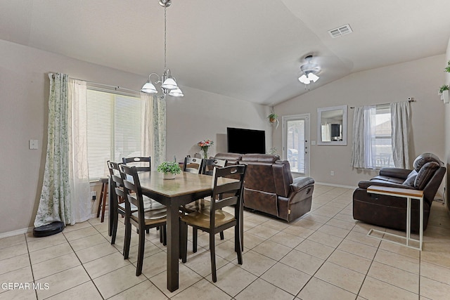 dining area with visible vents, baseboards, light tile patterned floors, a notable chandelier, and vaulted ceiling
