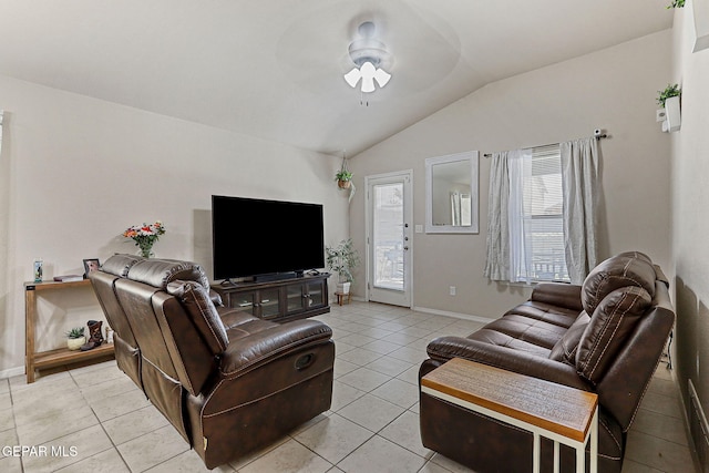 living room featuring light tile patterned floors, baseboards, a ceiling fan, and vaulted ceiling