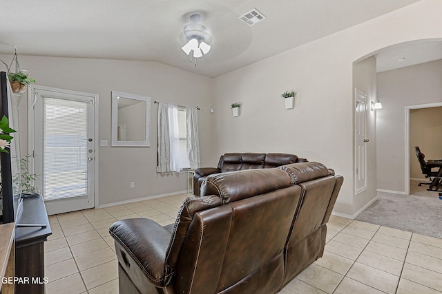 living area with ceiling fan, visible vents, arched walkways, lofted ceiling, and light tile patterned flooring