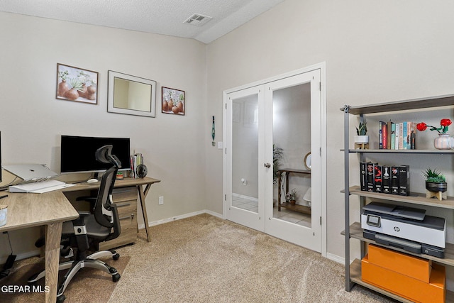 carpeted office with baseboards, french doors, a textured ceiling, and visible vents