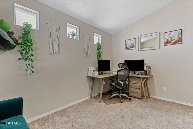 carpeted home office featuring baseboards, a textured ceiling, and vaulted ceiling