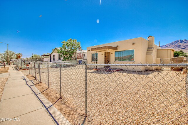 8929 Robert Dr Unit 1 & 2, El Paso, TX 79904 - pueblo-style house featuring fence, a mountain view, and stucco siding