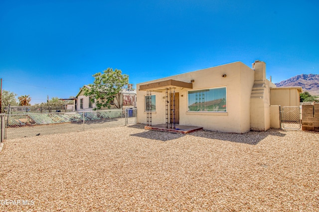 8929 Robert Dr Unit 1 & 2, El Paso, TX 79904 - southwest-style home featuring a mountain view, a gate, a fenced backyard, and stucco siding