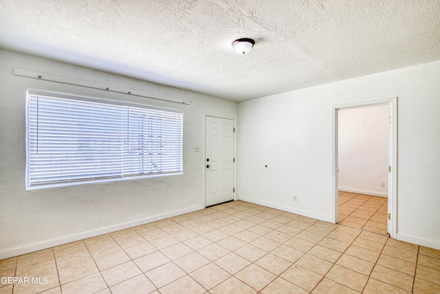 8929 Robert Dr Unit 1 & 2, El Paso, TX 79904 - empty room featuring baseboards, a textured ceiling, and light tile patterned flooring
