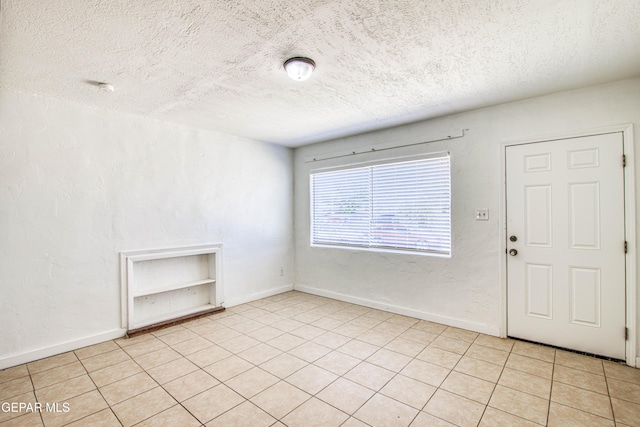 8929 Robert Dr Unit 1 & 2, El Paso, TX 79904 - foyer featuring baseboards, a textured ceiling, and light tile patterned floors