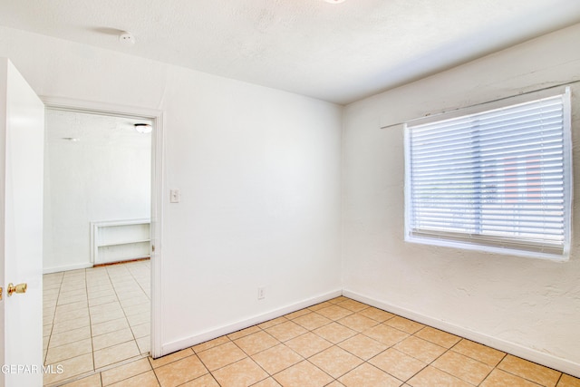 8929 Robert Dr Unit 1 & 2, El Paso, TX 79904 - spare room featuring light tile patterned floors and baseboards