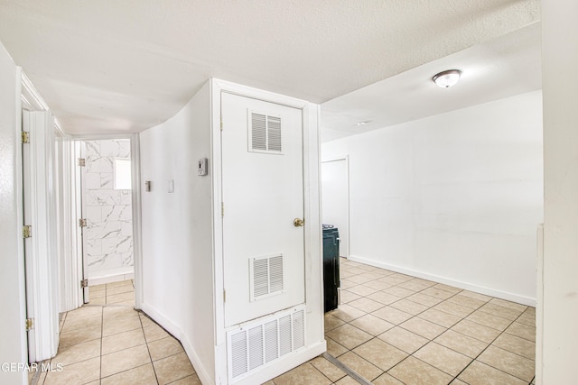8929 Robert Dr Unit 1 & 2, El Paso, TX 79904 - corridor featuring visible vents, baseboards, and light tile patterned floors