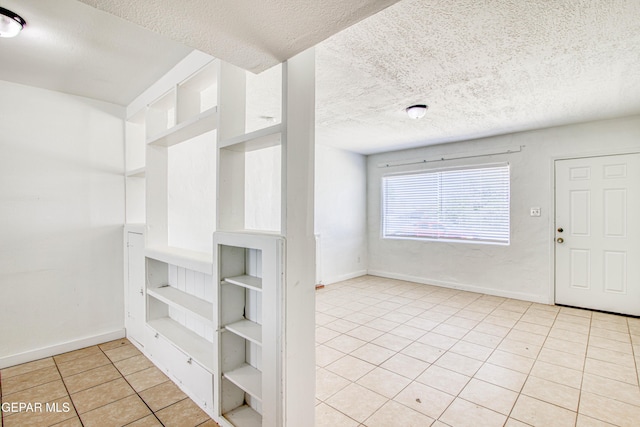 8929 Robert Dr Unit 1 & 2, El Paso, TX 79904 - spare room with a textured ceiling, baseboards, and light tile patterned flooring